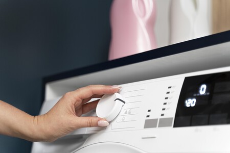 Woman Choosing Program Washing Machine